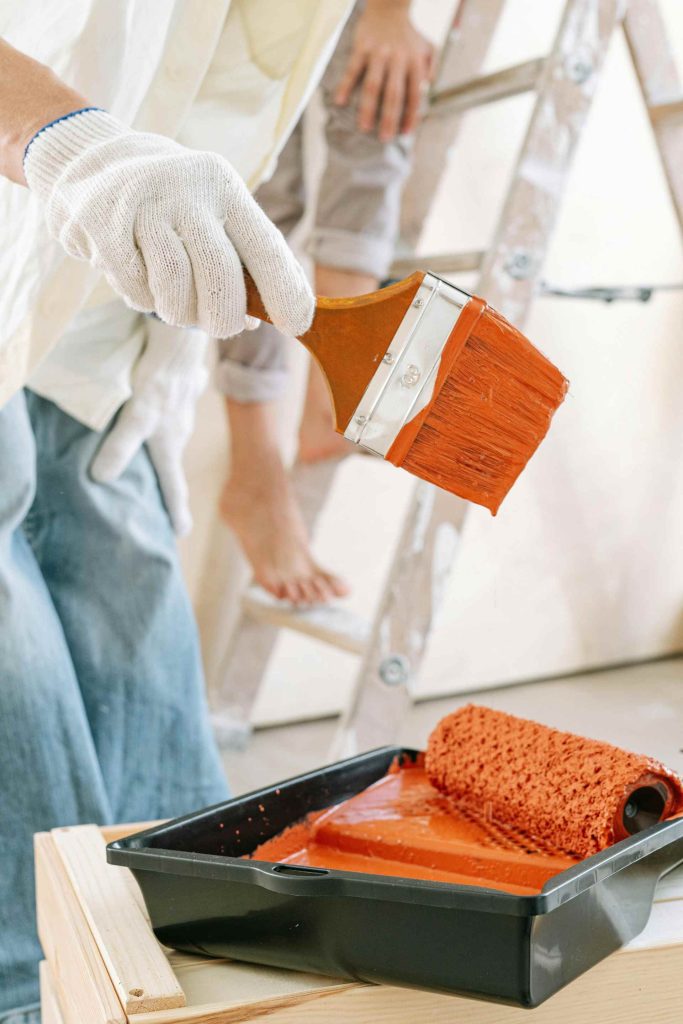 wall paint brush dipped in paint
