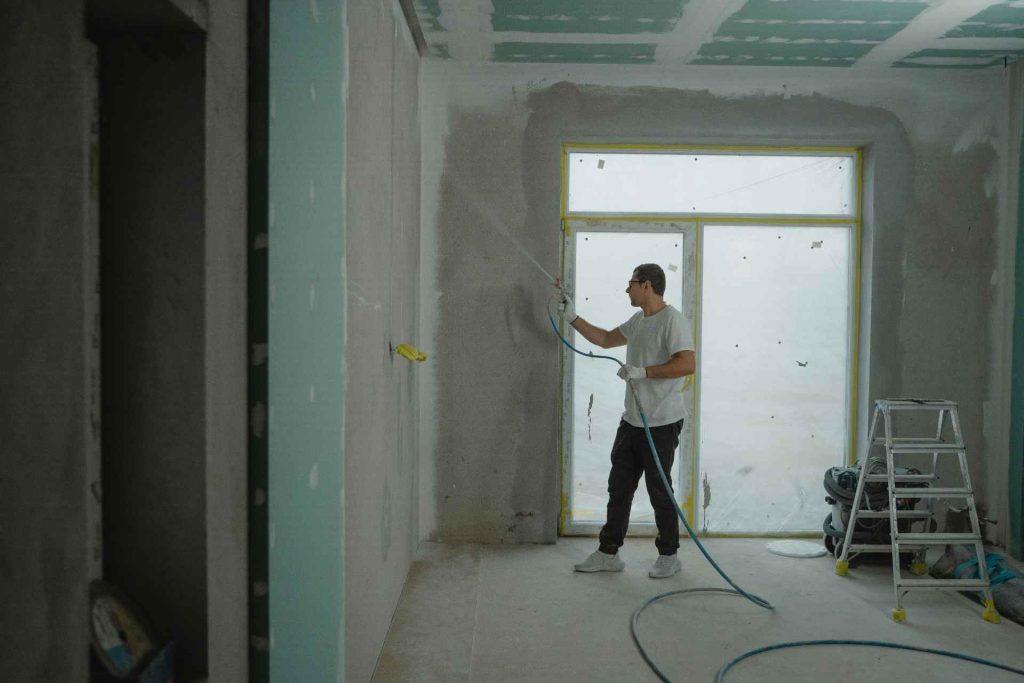 Man spray painting a wall